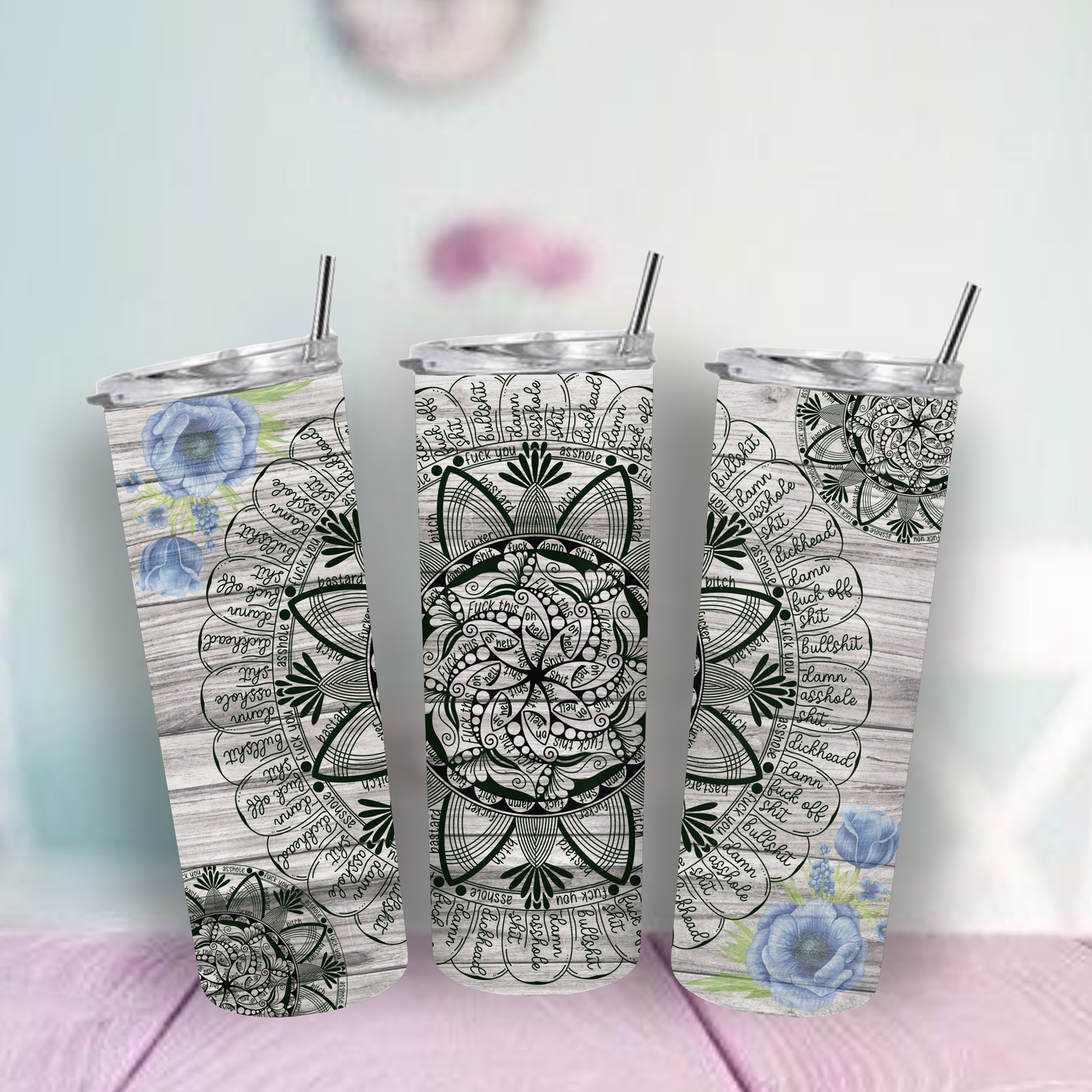 tumbler with floral and mandala designs on a light background