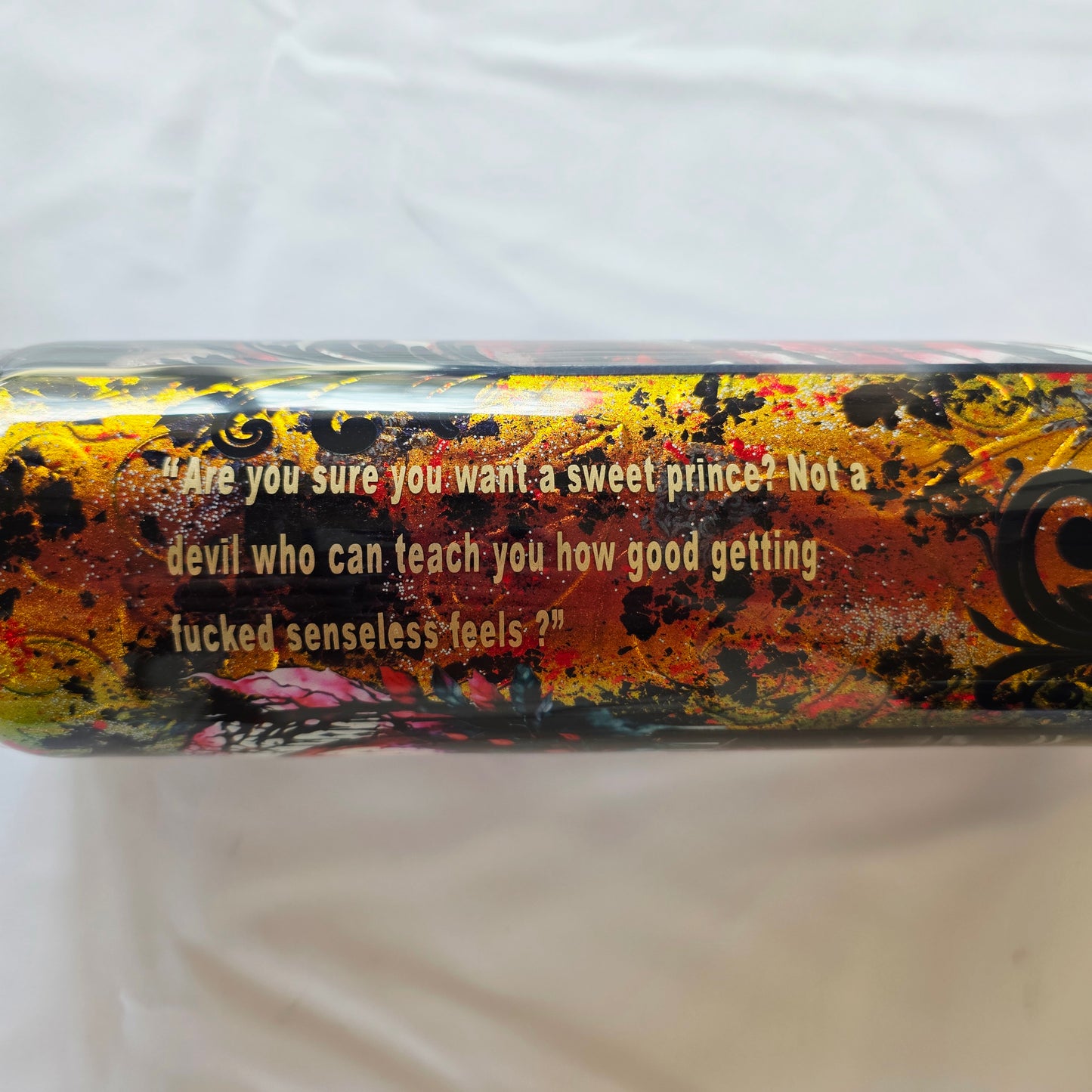 Decorative bottle with artistic design and text on a white background