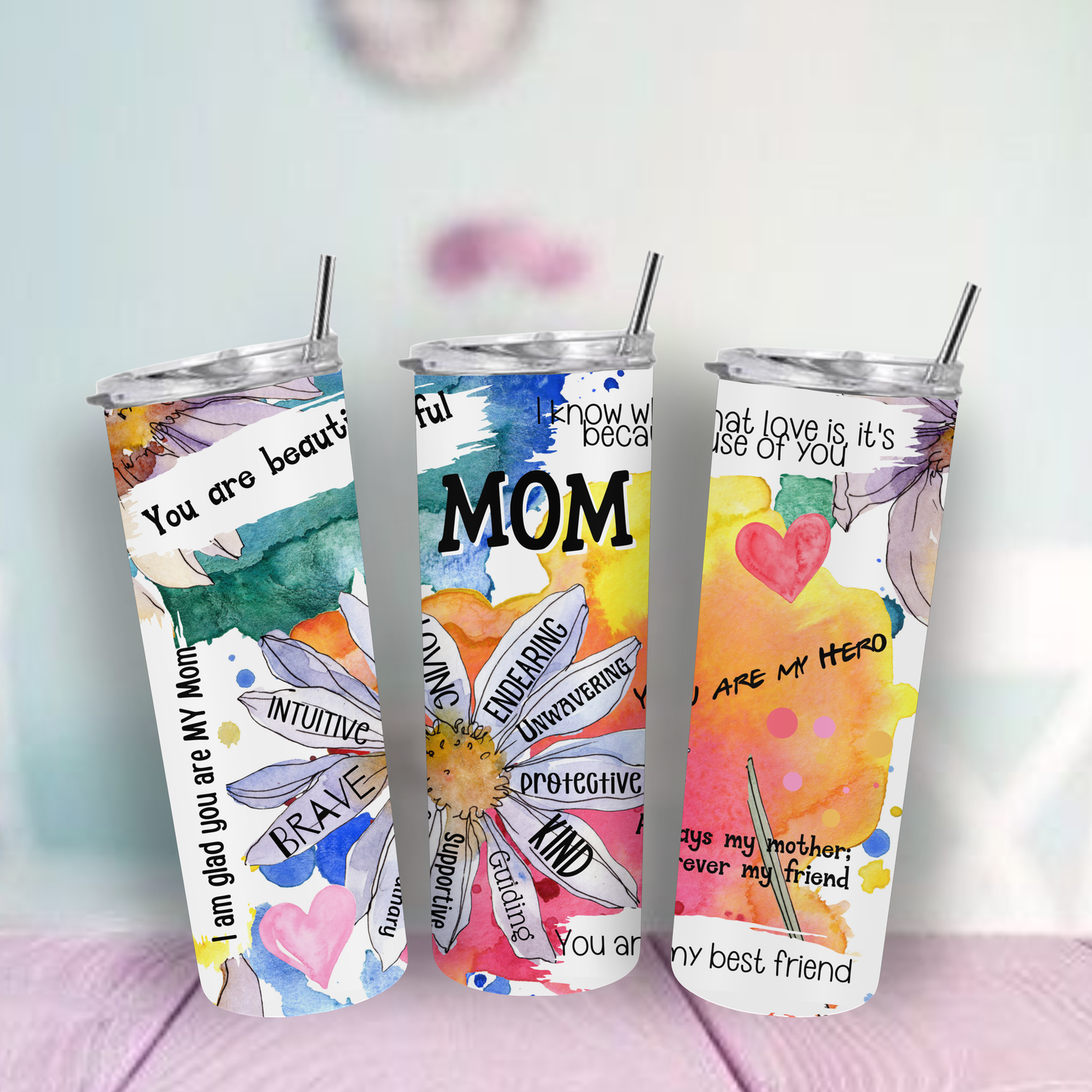 Tumbler with floral designs Best Mom and text on a multi-color surface.
